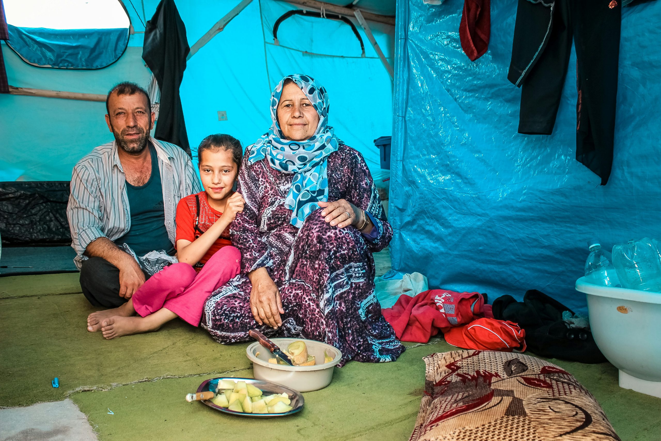 Family in the fron of tent in the refugee camp