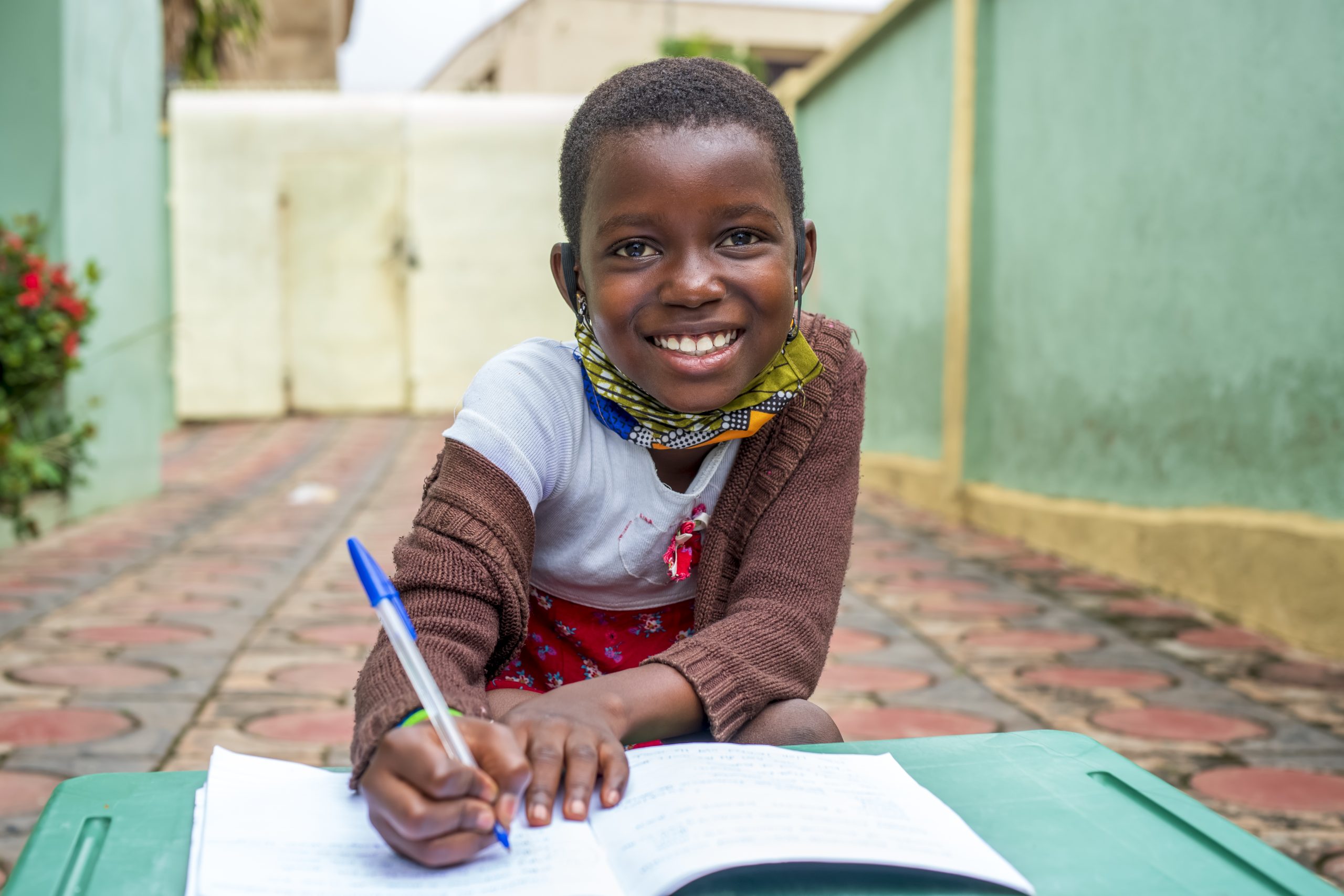 Closeup shot of child writing in a notebook
