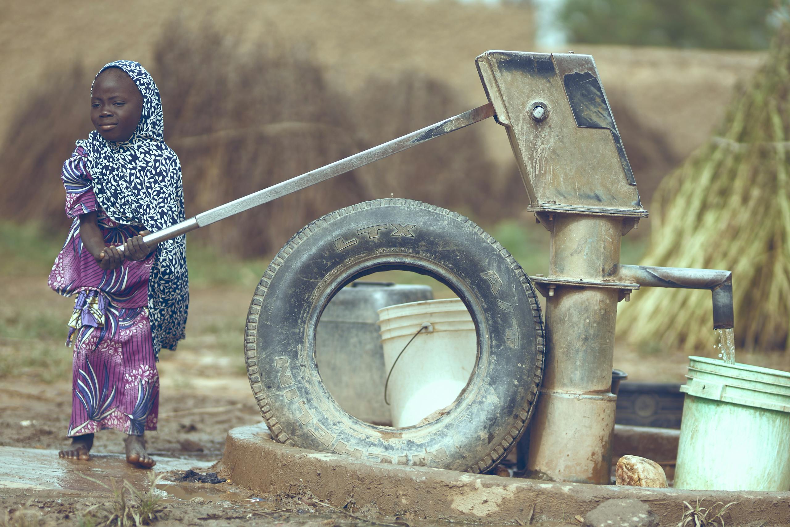 Sadaqah 1 Child fetching water from a well in Katsina, Nigeria, symbolizing rural life.